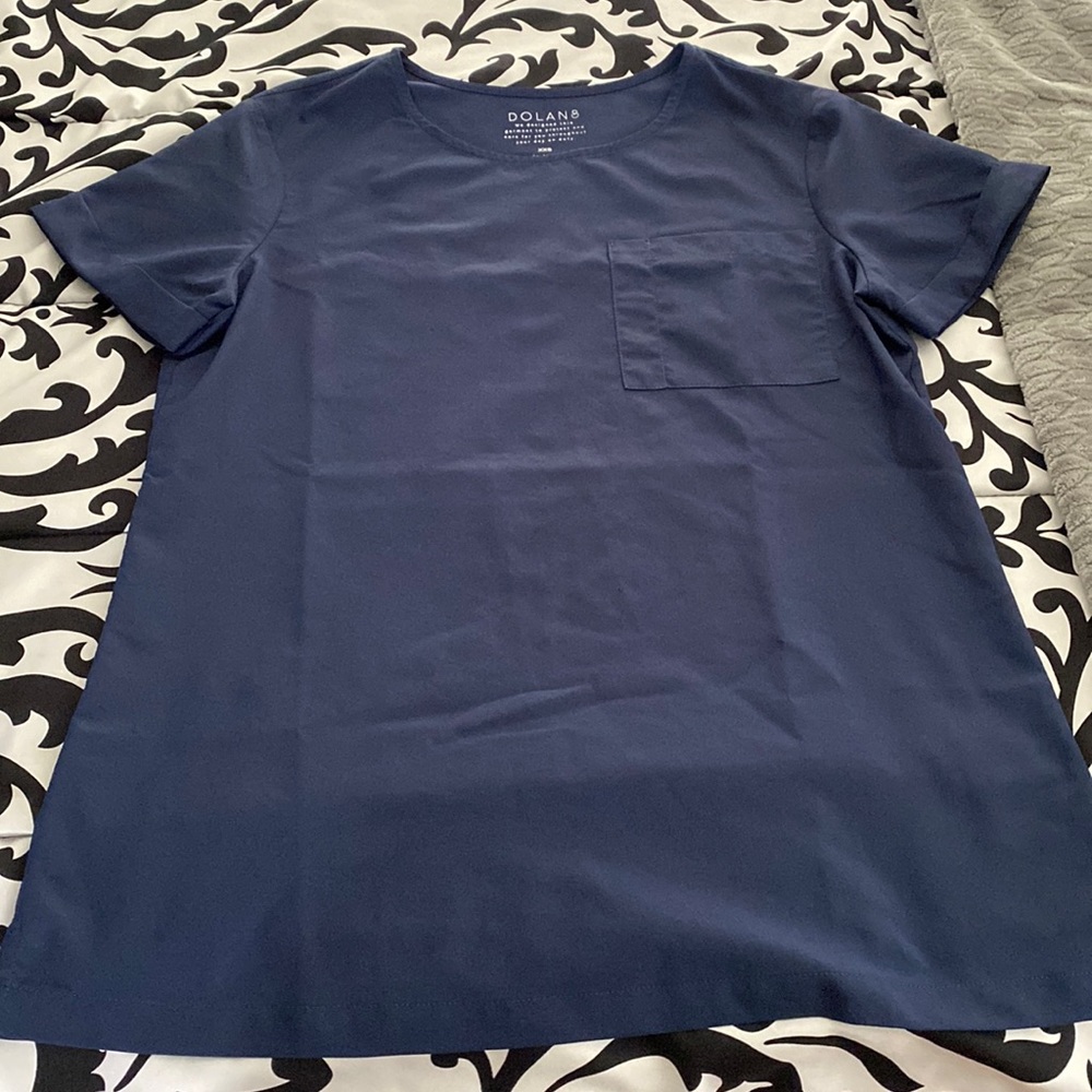His is a Dolan navy blue top. Is supposed to have the t shirt feel!